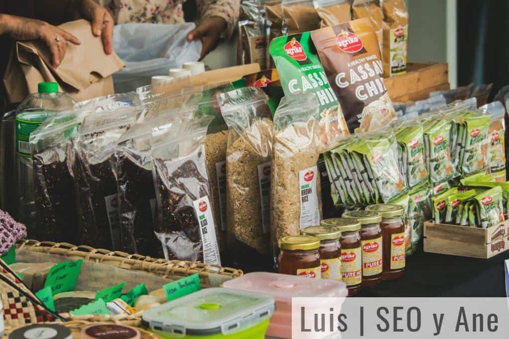 An assortment of packaged foods displayed on a market stall indoors, showcasing variety.
