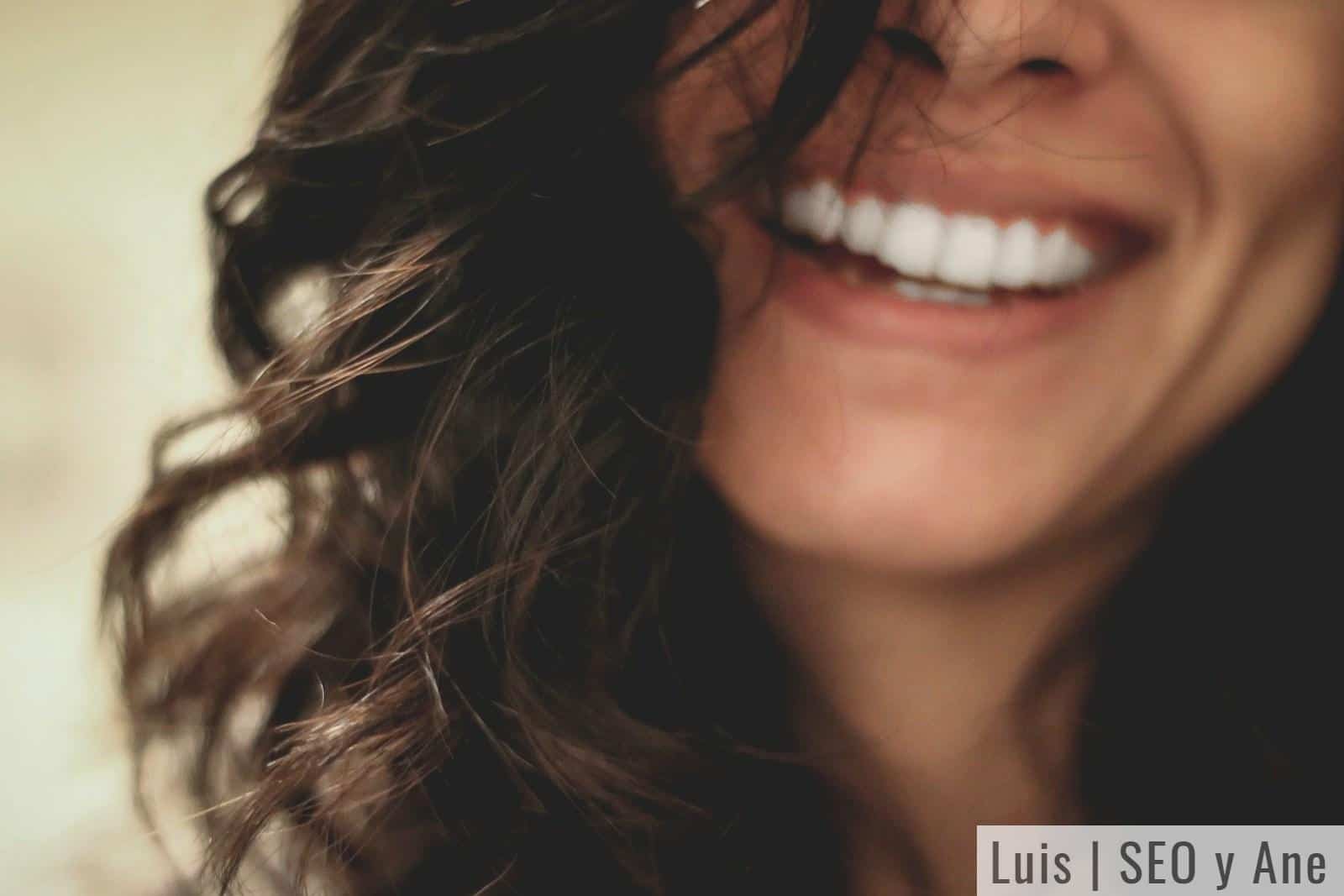 long black haired woman smiling close-up photography