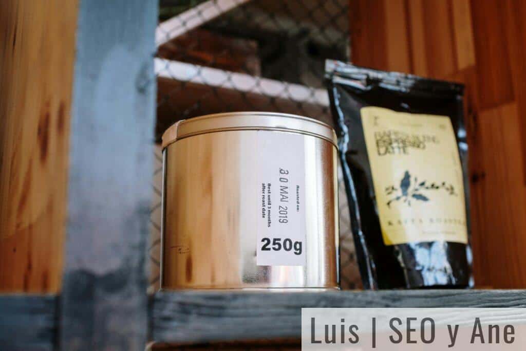 Close-up of coffee products on a wooden shelf, ideal for cafes or loft-style kitchens.