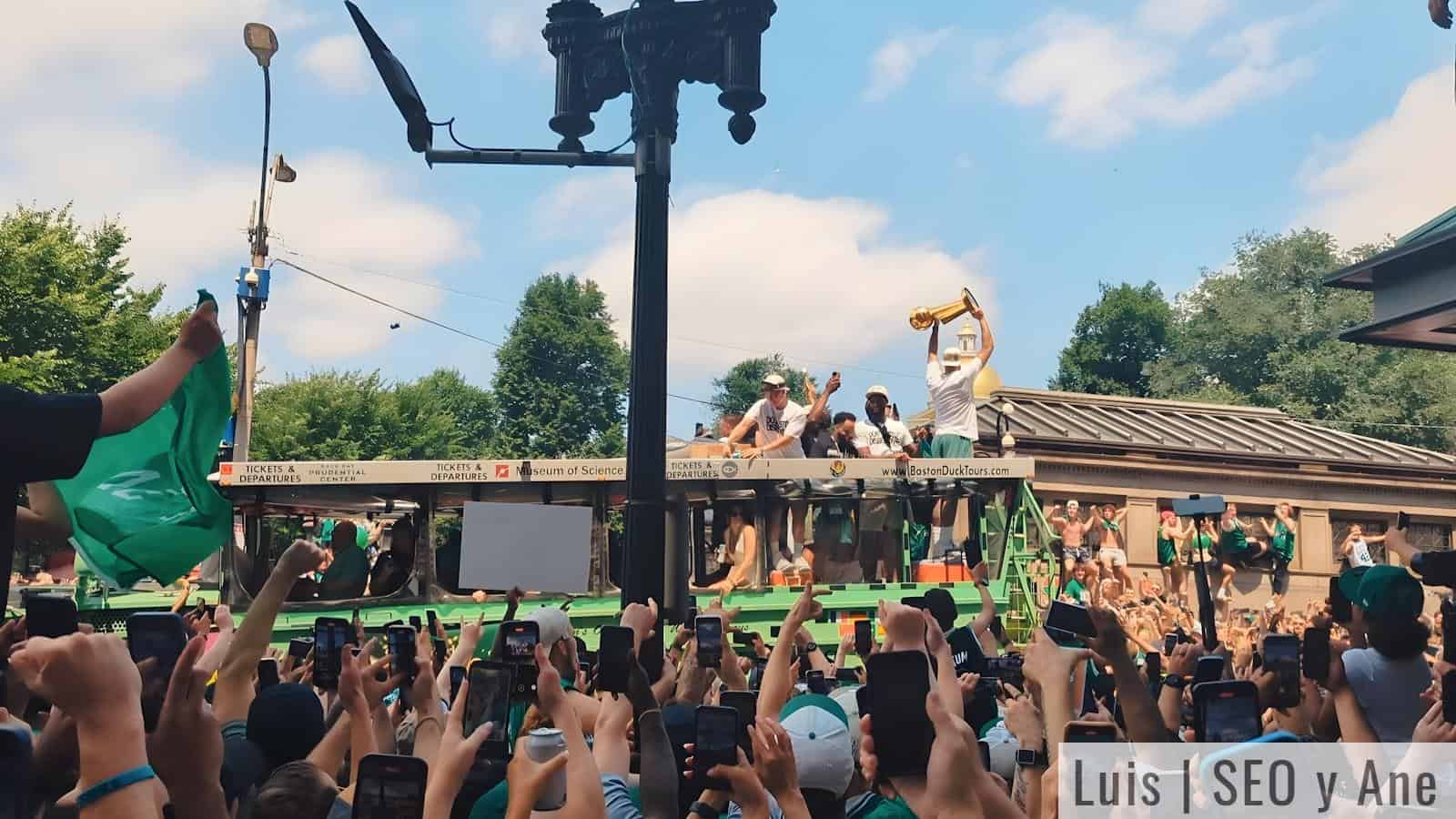 A crowd of people are taking pictures of a float